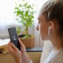 a girl watches the social network Tik Tok on her smartphone